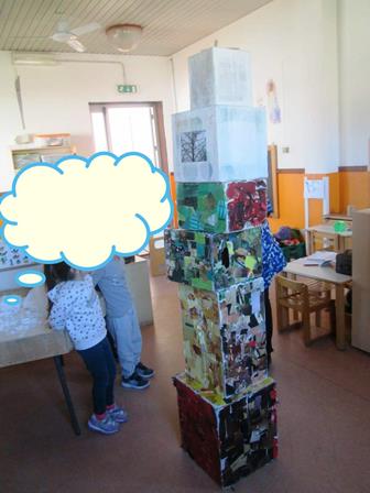 I bambini osservano una torre di scatoloni che hanno appena costruito